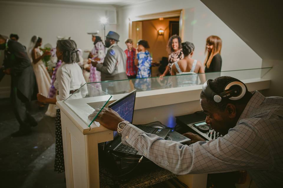 Wedding DJ looking at laptop